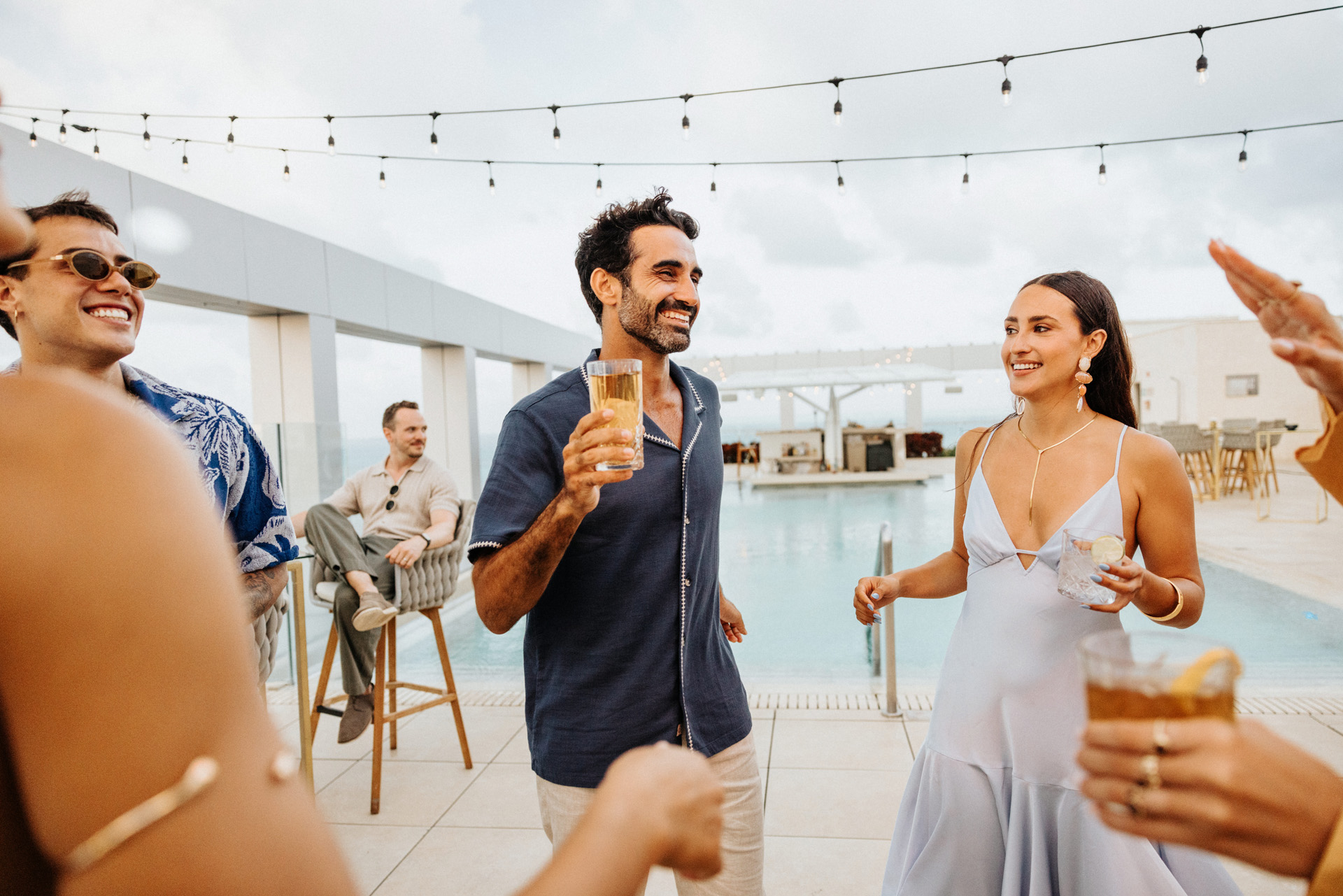 People socializing at a rooftop bar in Cancun at Amàre Cancún